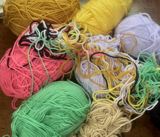 Multiple skeins of yarn that are tangled and messy